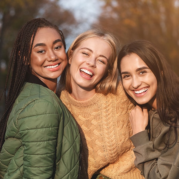 Friends smiling at Modern Orthodontics in Long Beach, CA